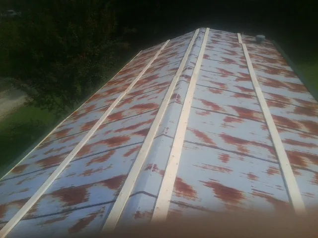 Rusted metal roof panels with new wood purlins before replacement — Storm Damage Roof Repair in New London by Roofing Brothers